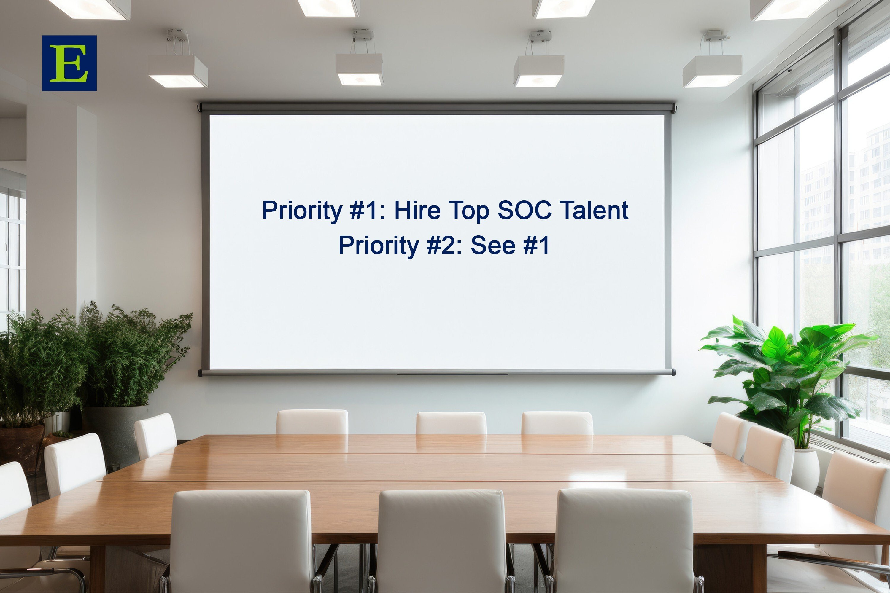 Boardroom screen above table and chairs with words Priority #1 Hire Top SOC Talent Priority #2 See #1