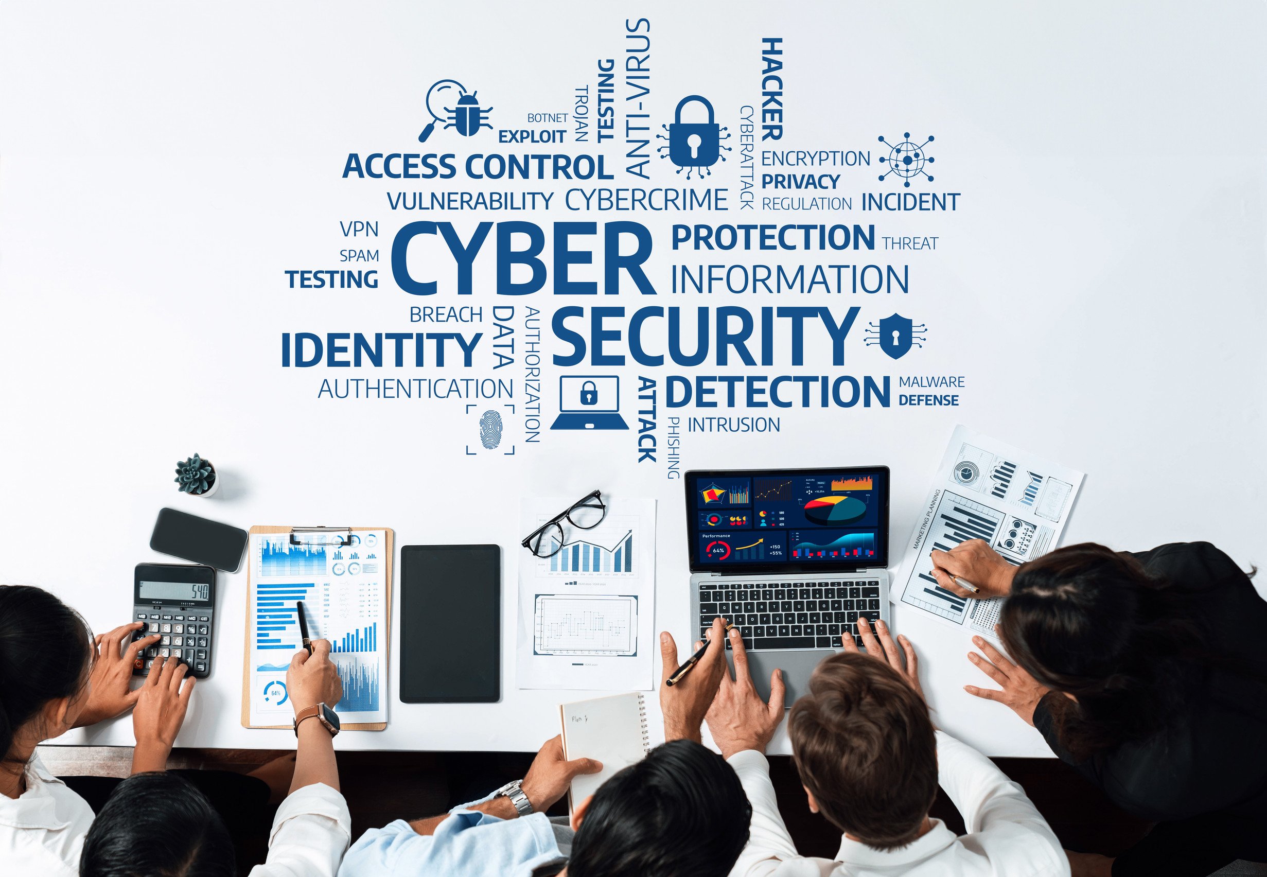 Team sitting around table trying to figure out cybersecurity needs and data beneath cyber threat word cloud