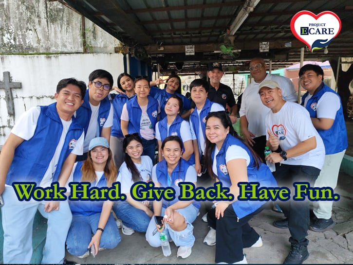 ECLARO Project E-Care Volunteers with Project E-Care logo and Work Hard. Give Back. Have Fun. copy at Manila North Cemetery