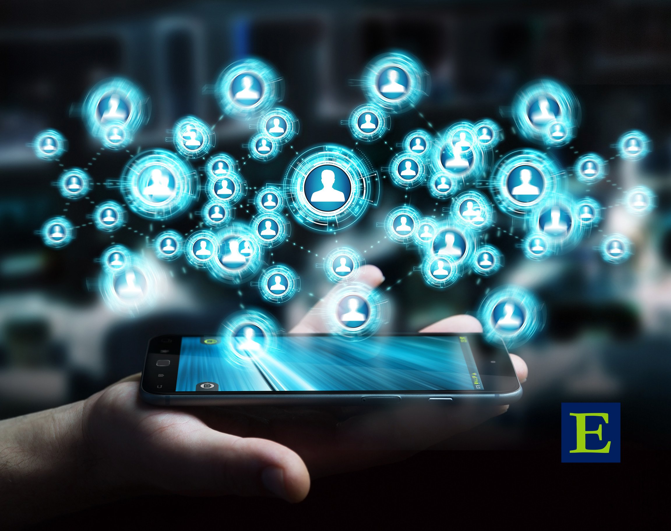 Social media icons floating over a glowing smartphone held in a hand