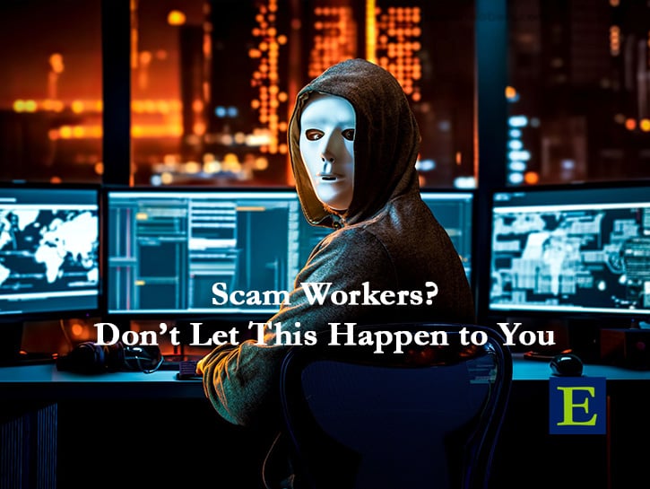 hacker in mask sitting in front of monitors with city in background